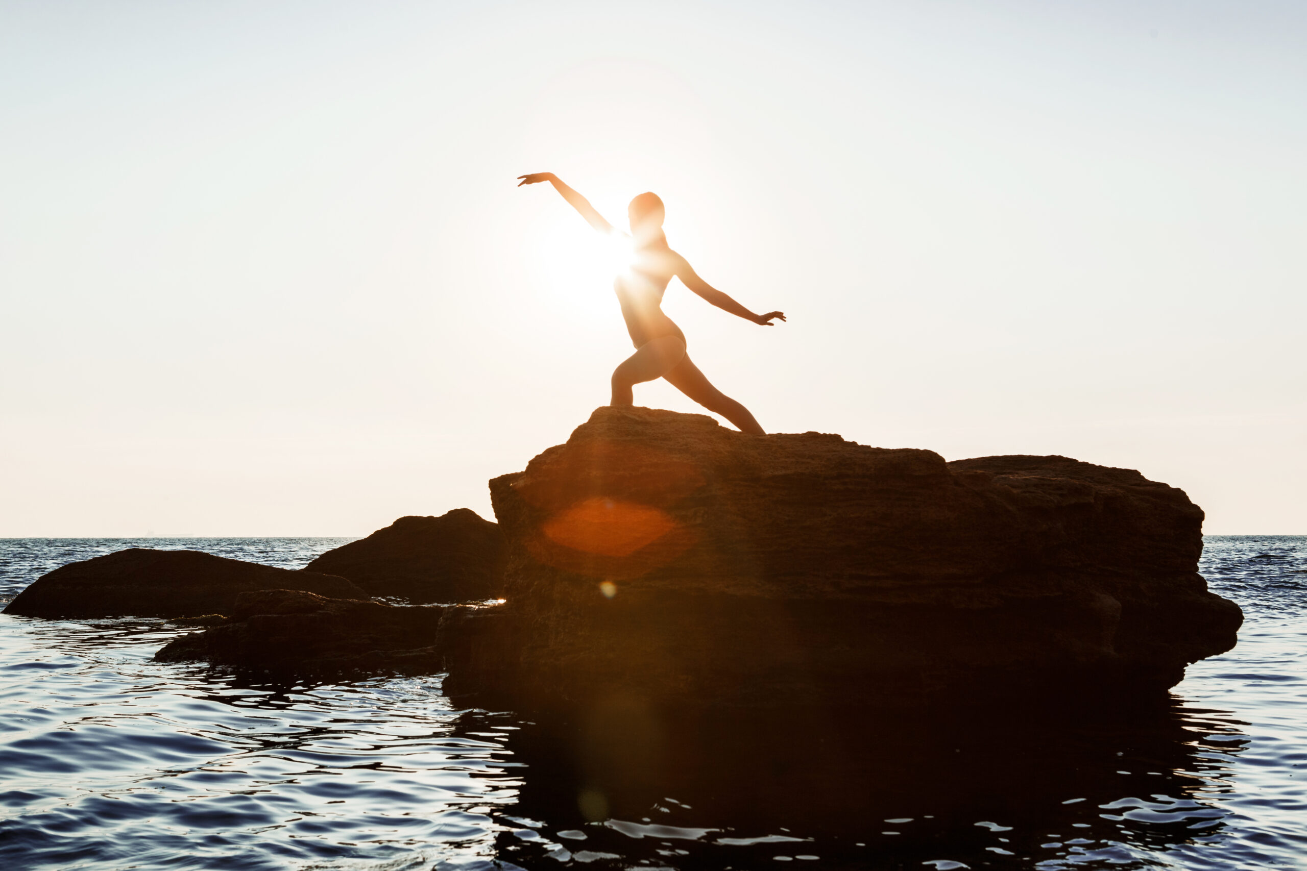 Ballerina silhouette posing on rock, symbolizing human connection and leadership in an AI world.