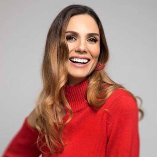 Keynote speaker and wellness expert Alison Canavan smiling in a red top.