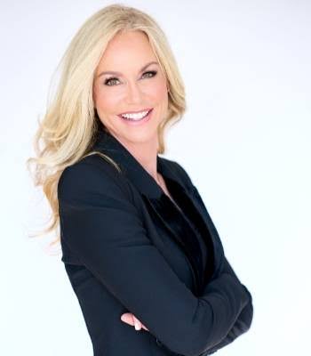 Amberly Lago, motivational keynote speaker and bestselling author, smiling in a black blazer.