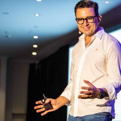Keynote speaker Christian Boo Boucousis presenting on stage during an event.
