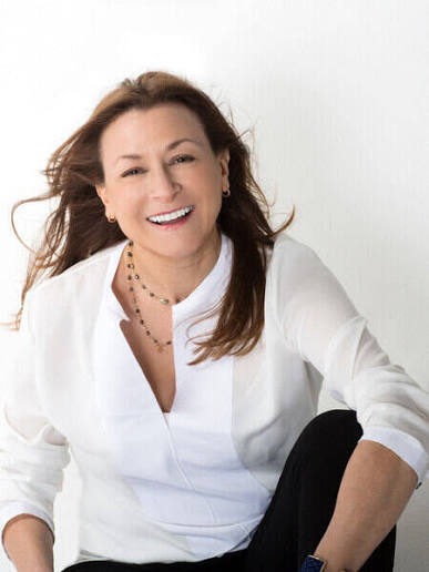Jeanne Bliss, customer experience keynote speaker and expert, smiling in white attire.