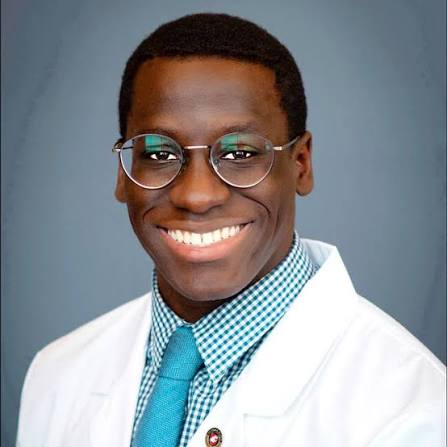 Dr. Joel Bervell, keynote speaker and healthcare equity advocate, wearing a white coat.