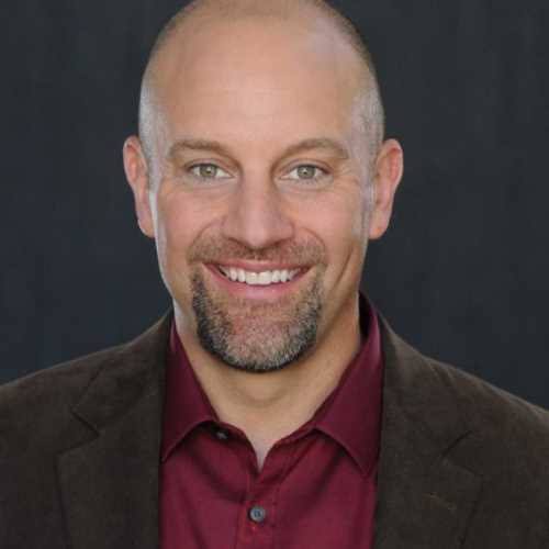 Keynote speaker and leadership expert Mike Robbins smiling in a professional portrait.