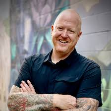 Global futurist and keynote speaker Nikolas Badminton smiling with arms crossed.