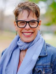 Pamela Malkoff, burnout keynote speaker and psychotherapist, smiling outdoors.