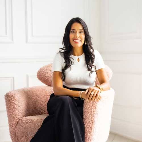 Ritu Bhasin, keynote speaker and DEI expert, sitting in a pink armchair.
