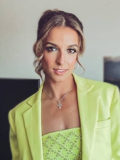 Motivational speaker and television personality Victoria Arlen wearing a lime green blazer.